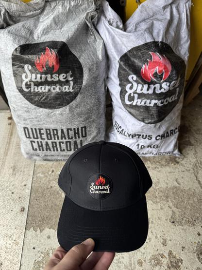 Kaksi säkkiä hiiliä ja sunset charcoal musta lippis.